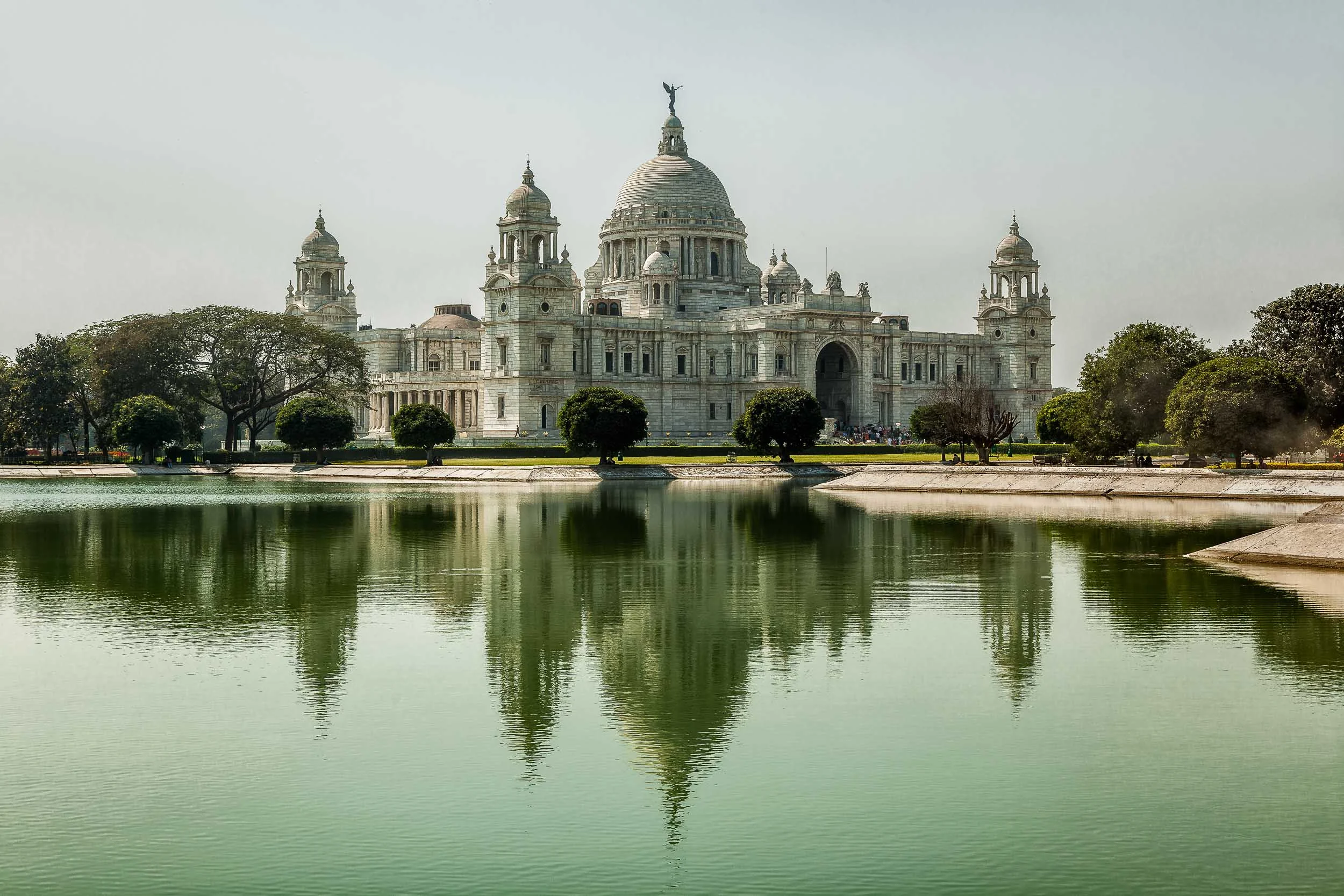 Victoria Memorial and its reflection in the placid waters of a man made lake in Kolkata, India .