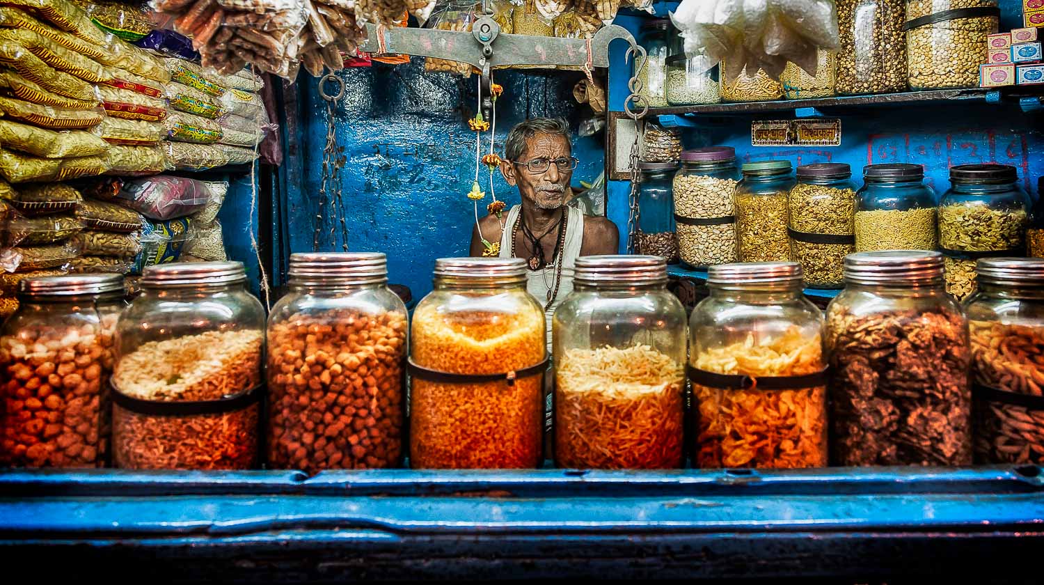 Retailer, in his tiny blue van, Kolkata. Link to Travel Resources page.