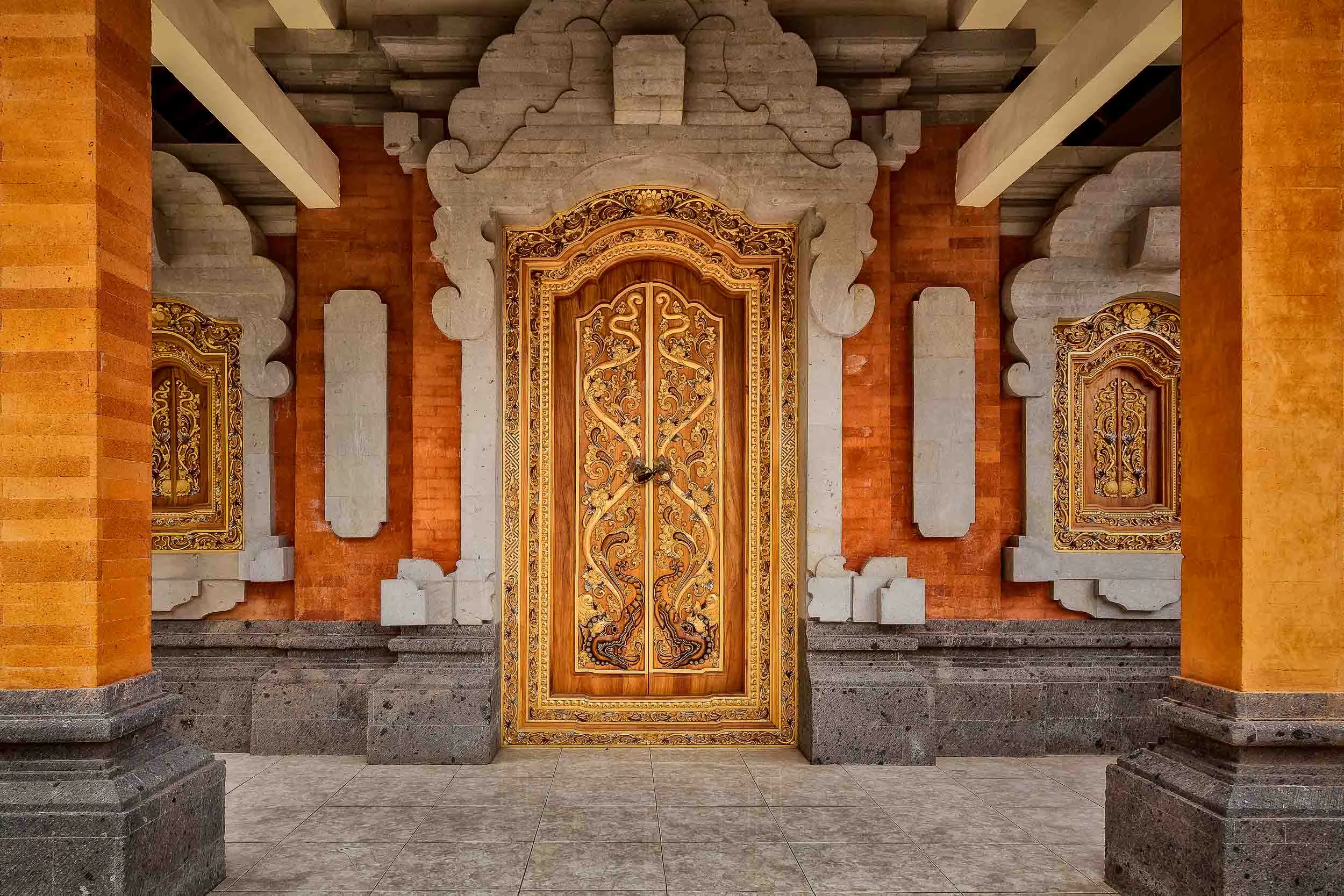 An ornate, c olorful door marks the entrance to a Hindu temple in rural Bali, Indonesia .