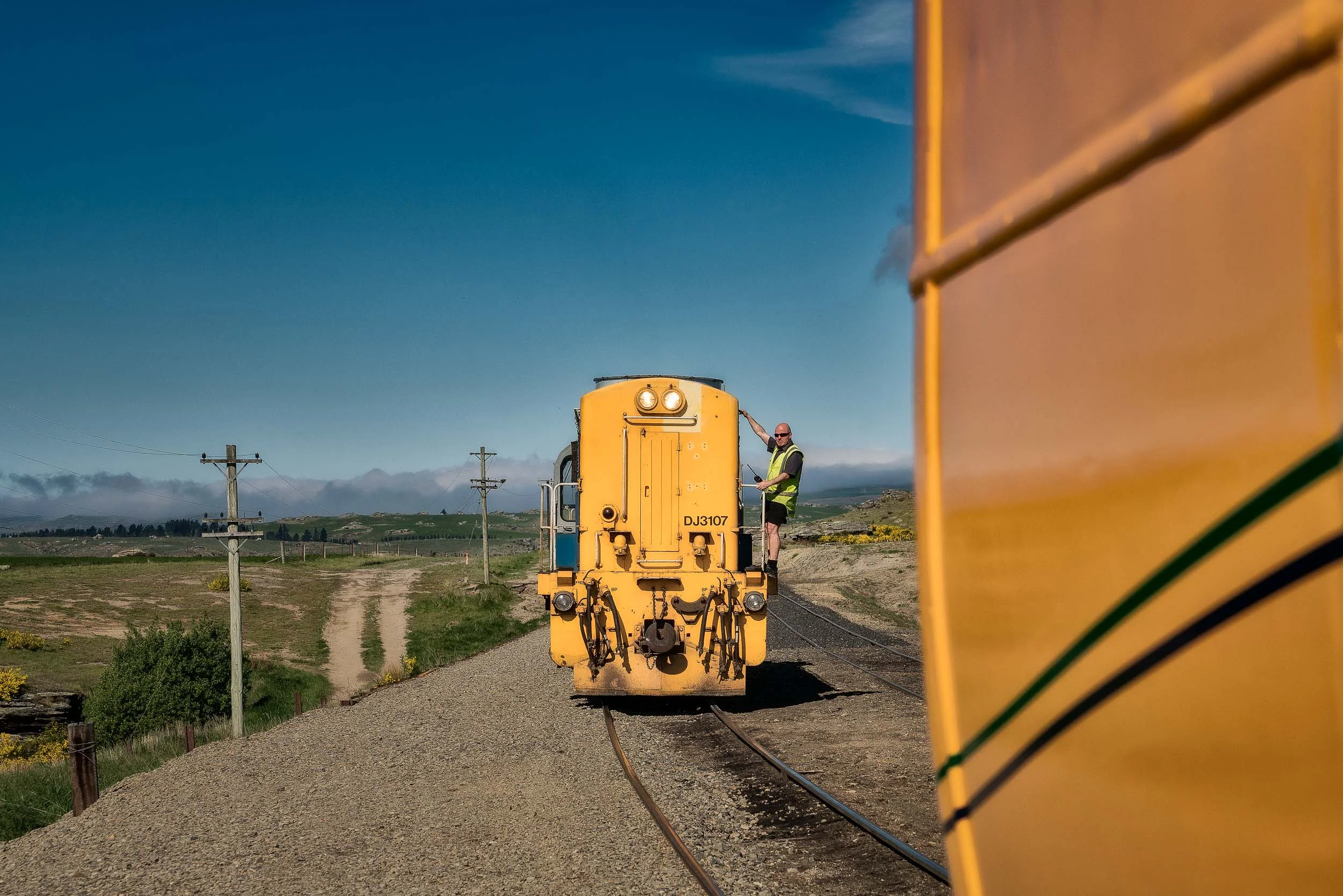 A workman about to link carriages on the Taieri Gorge Railway line near Dunedin in New Zealand .