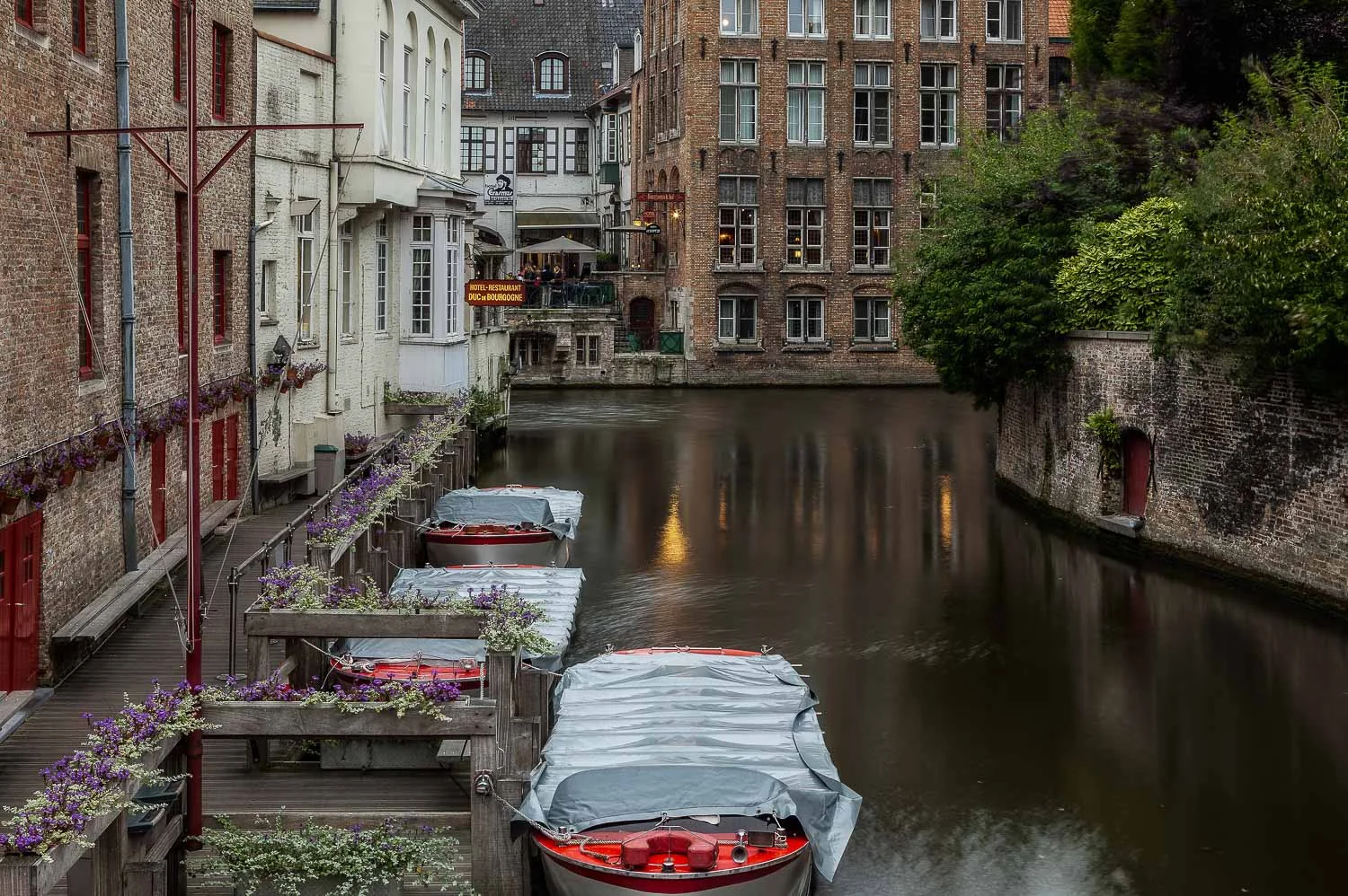 A lovely, restful photo of boats moored on the canal in the city of Bruges, Belgium .