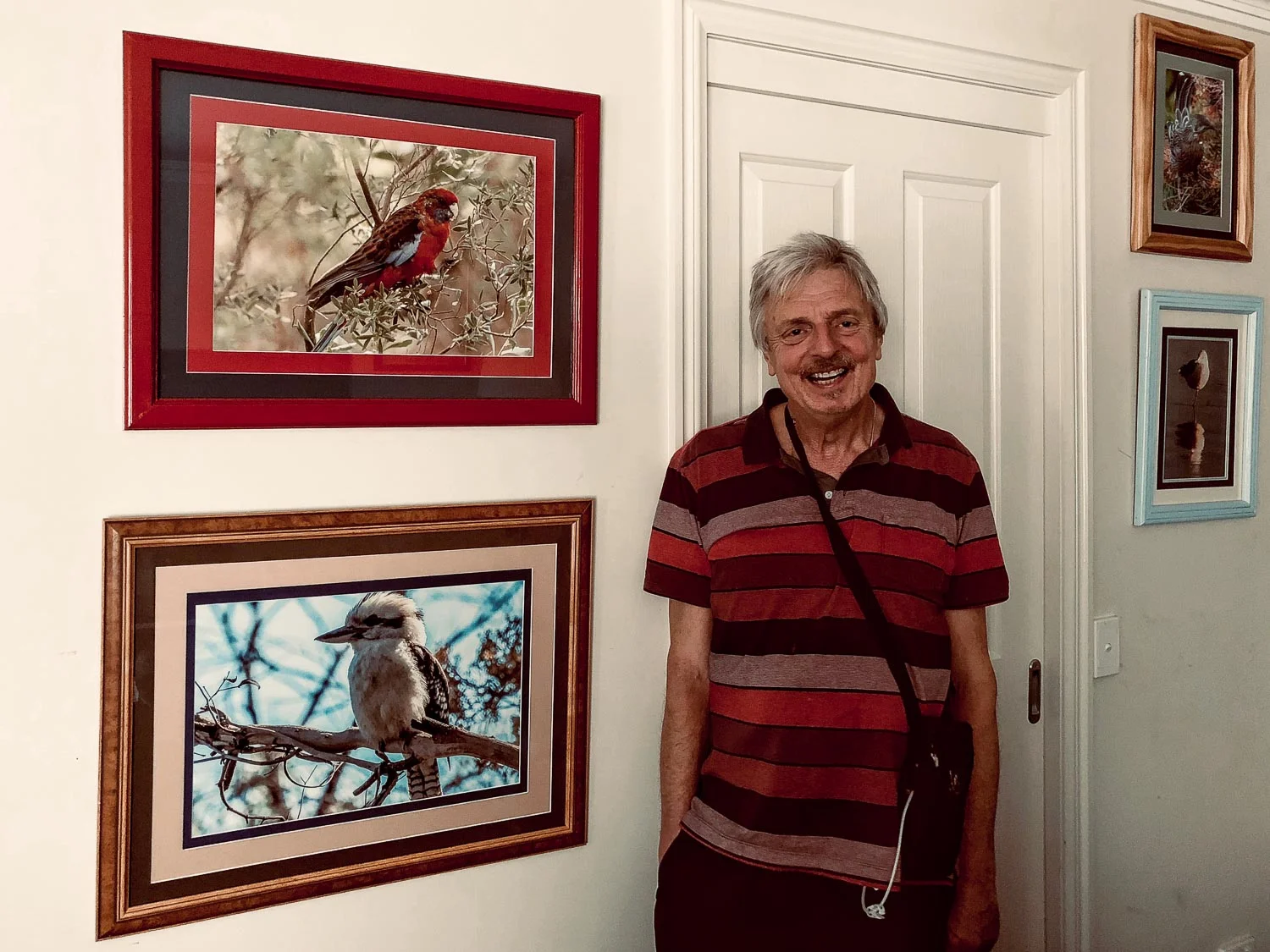 Ralph Holland at home with some of his framed photos on display.