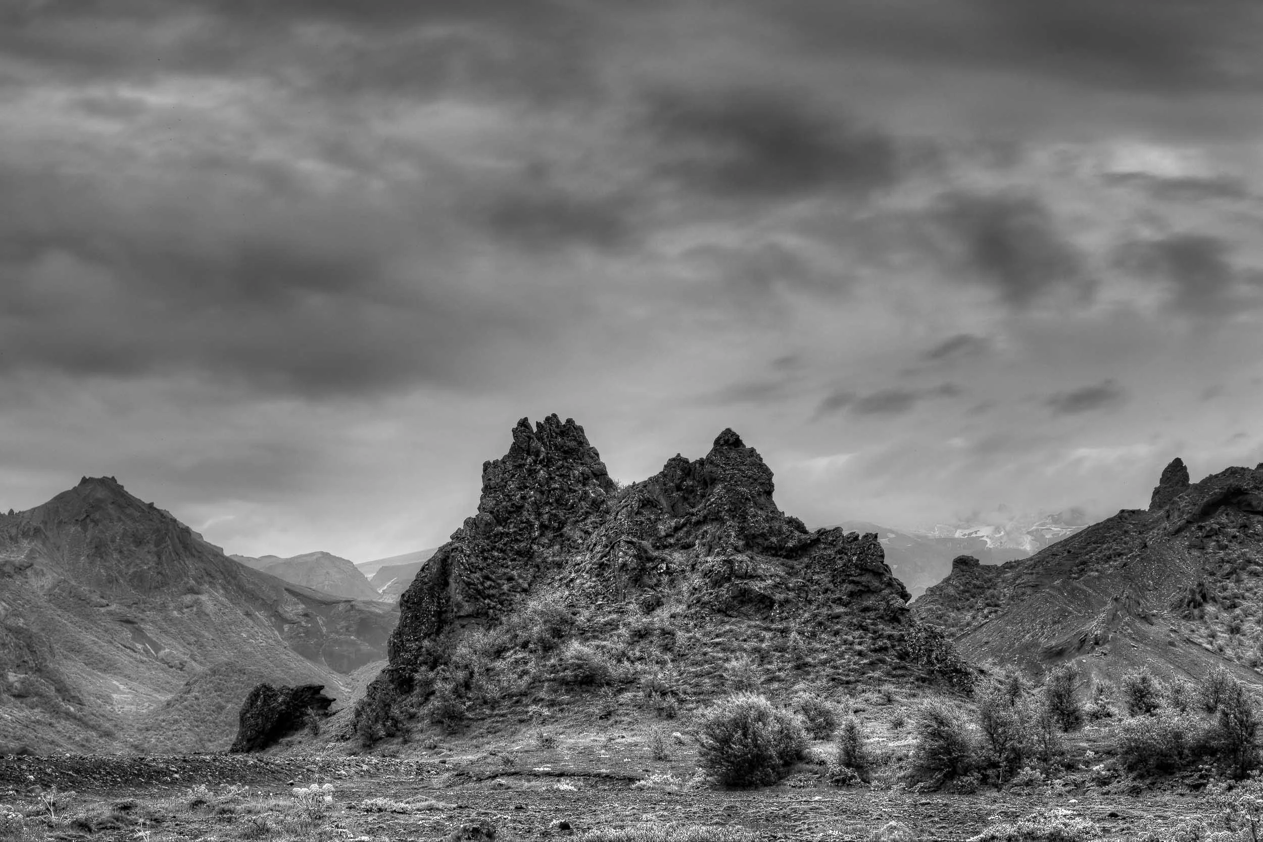 A black and white photo depicting the rugged beauty of the Highlands in Central Iceland .