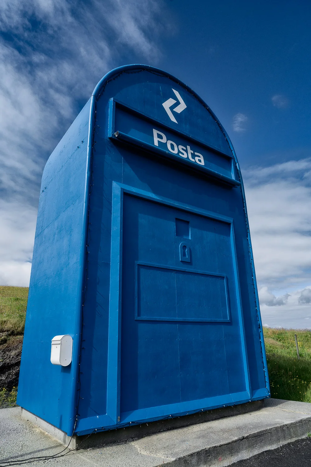 Photographing the huge Skopun mailbox in a way that accentuates visual perspective.