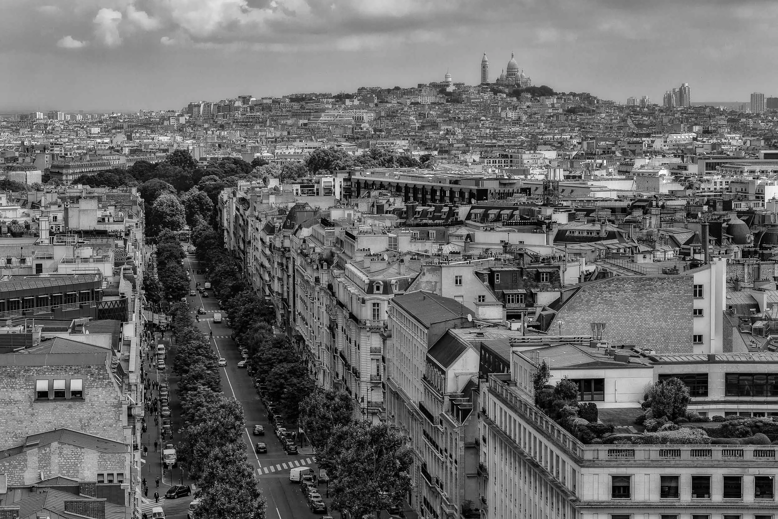 A rooftop view towards the Sacre Coeur Basilica on Montmarte in Paris from atop the Arc de Triomphe .