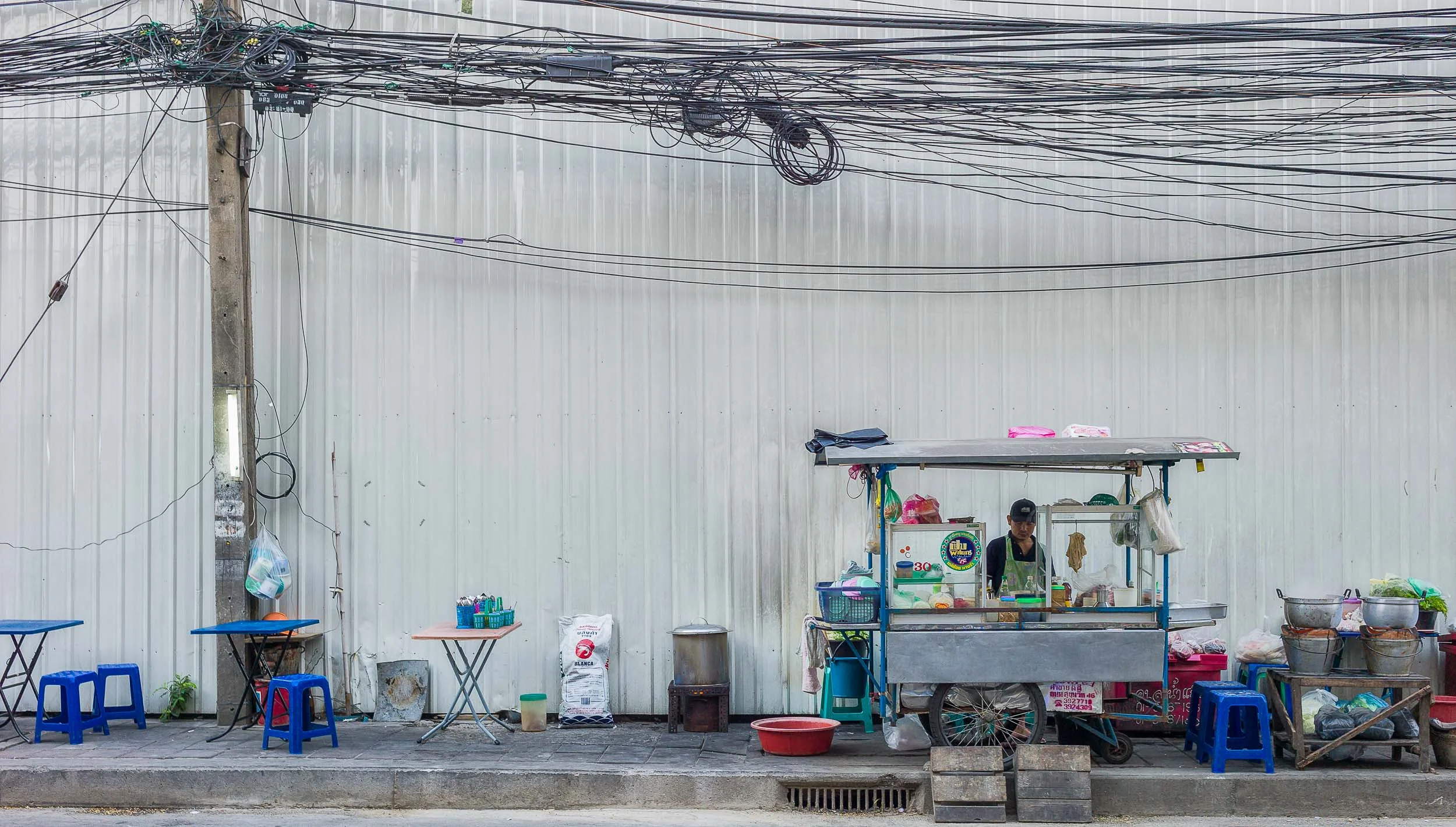 A typical street scene in Bangkok with a food vendor set up on a pedestrian sidewalk. Street food is usually very taste, inexpensive and safe in Bangkok.