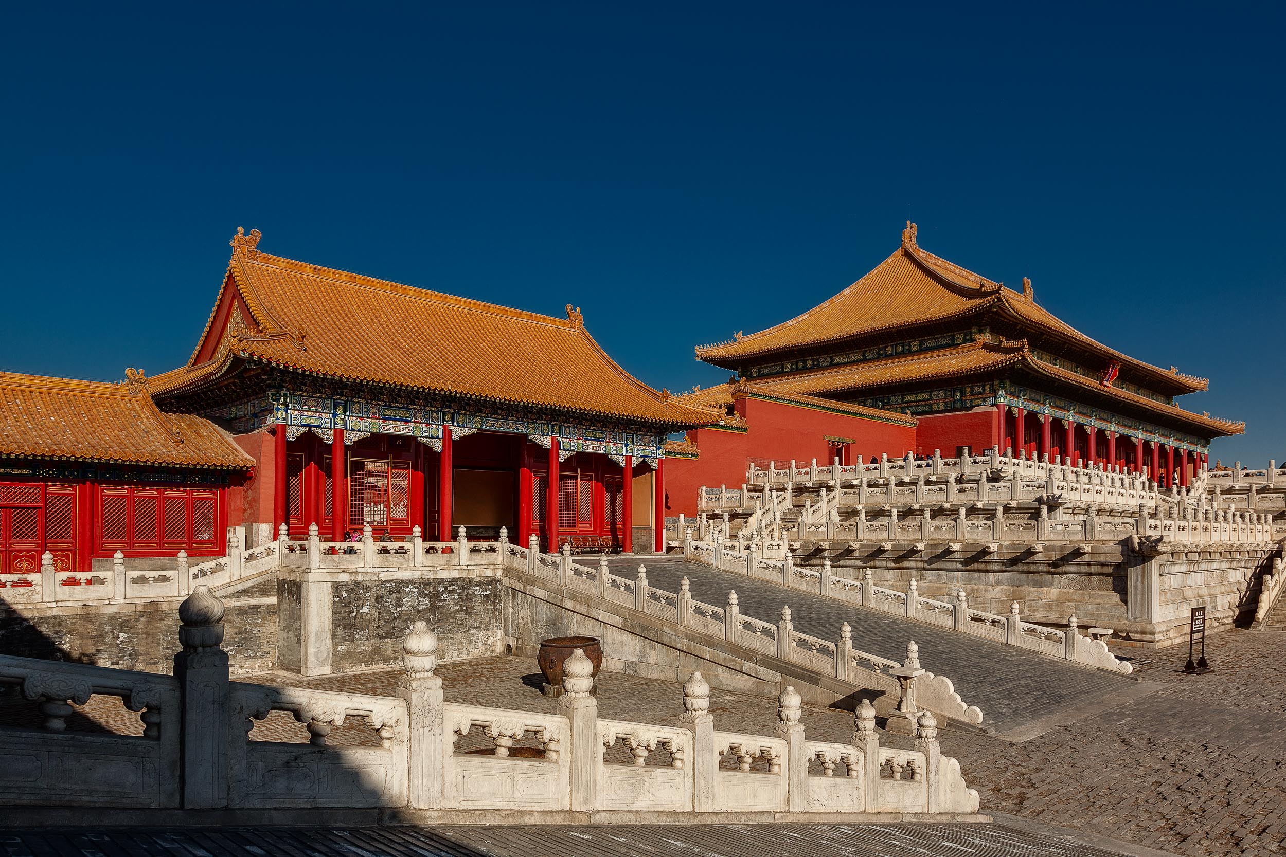 Red walls, orange tiled roofs and blue sky at the Forbidden City.