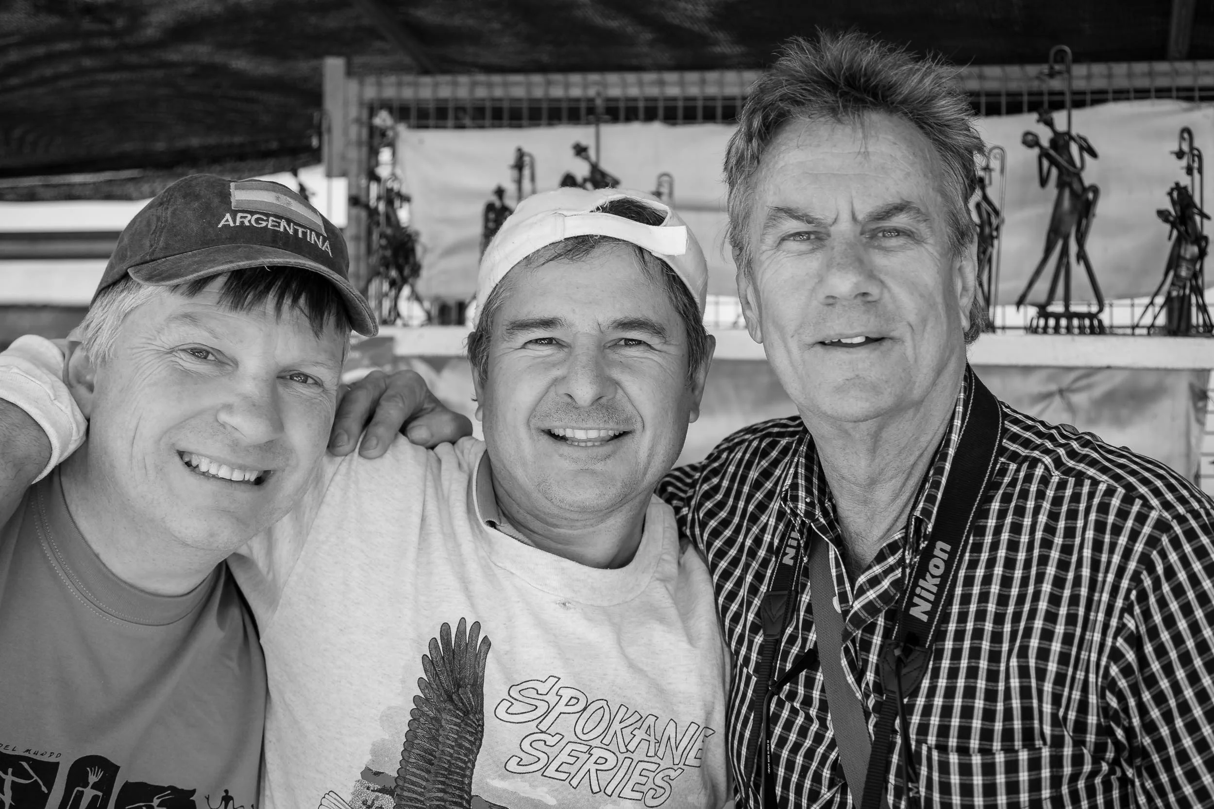 Glenn Guy , the Travel Photography Guru , with a local retailer and Col Pearson, a participant in a photography tour Glenn co-ran at a market in Buenos Aires, Argentina . Photographer Unknown.