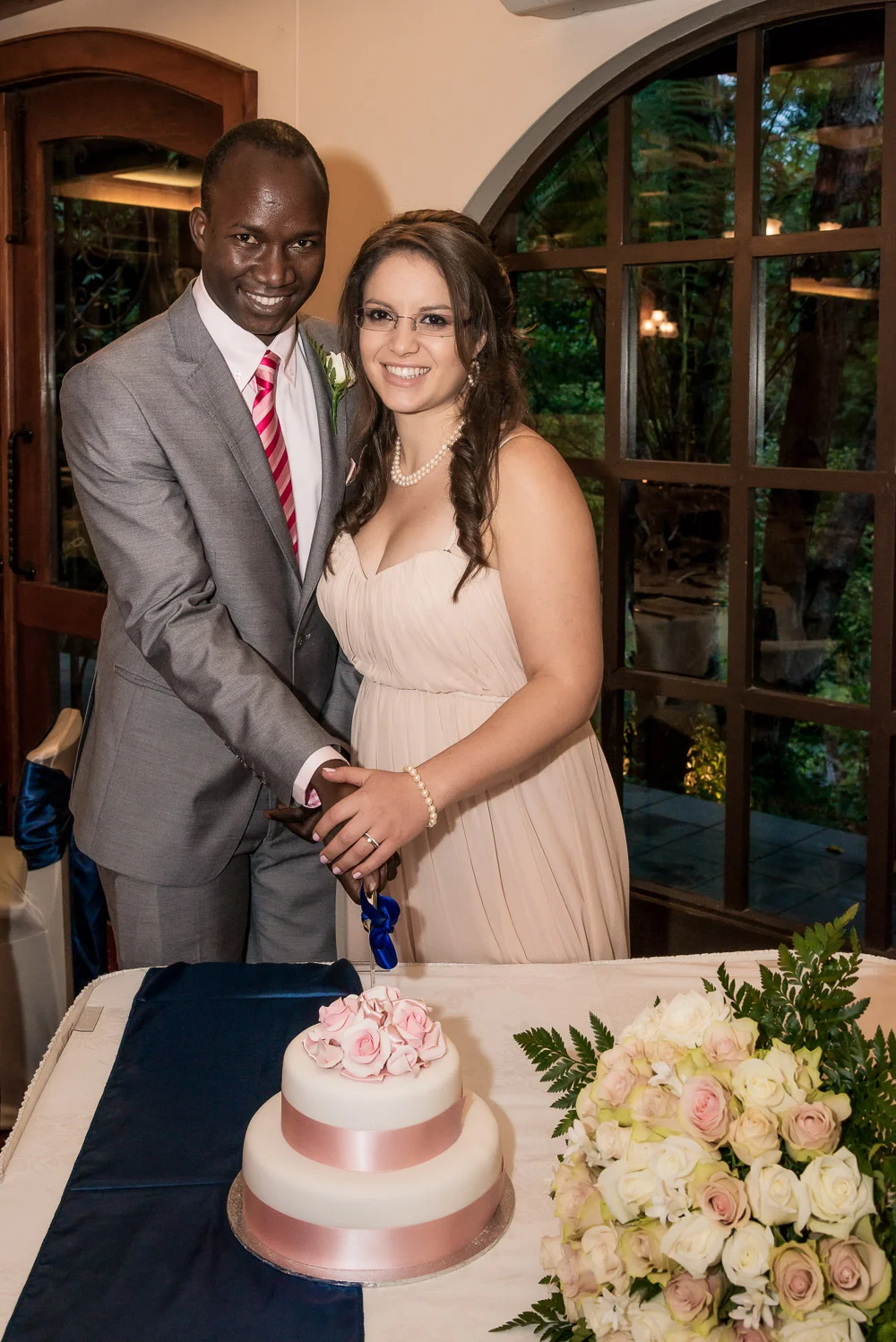 The bride and groom cutting the Wedding cake at the reception.
