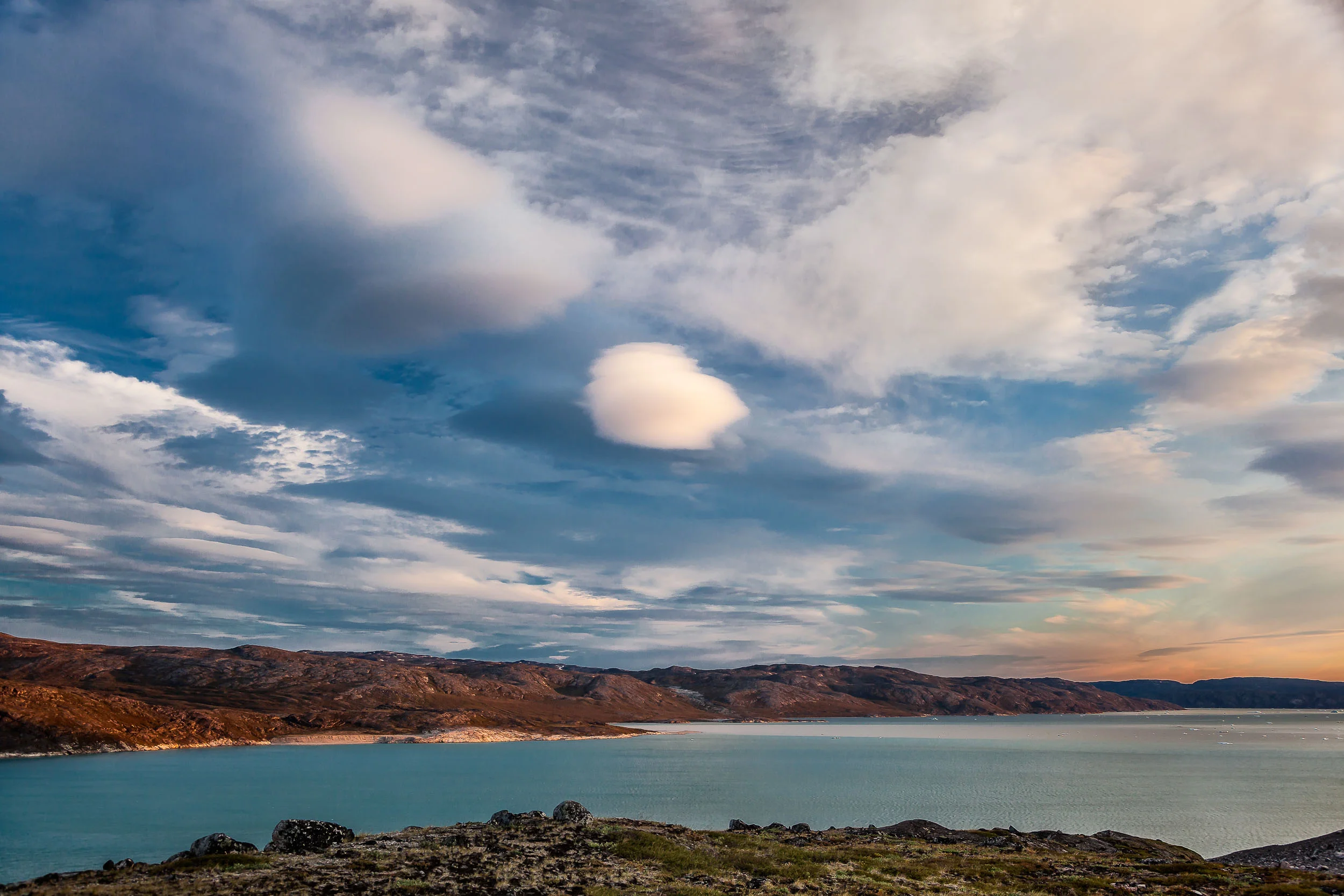 Interesting clouds above Disko Bay in Western Greenland .