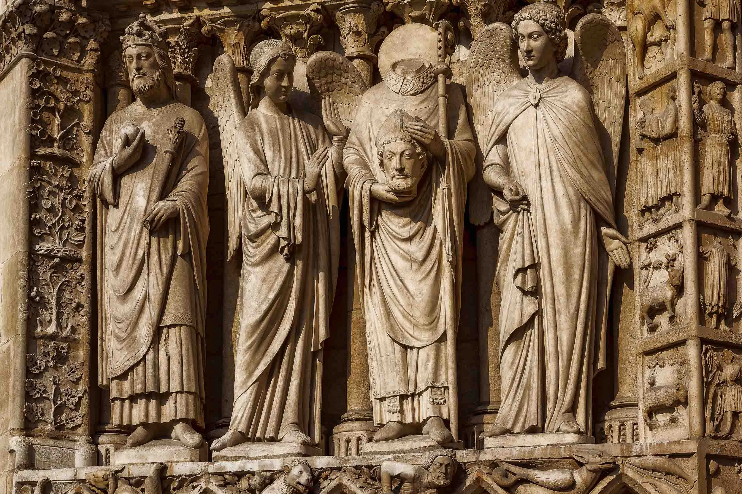 Wonderfully detailed statues high up on the facade of the Notre Dame Cathedral in Paris, France.