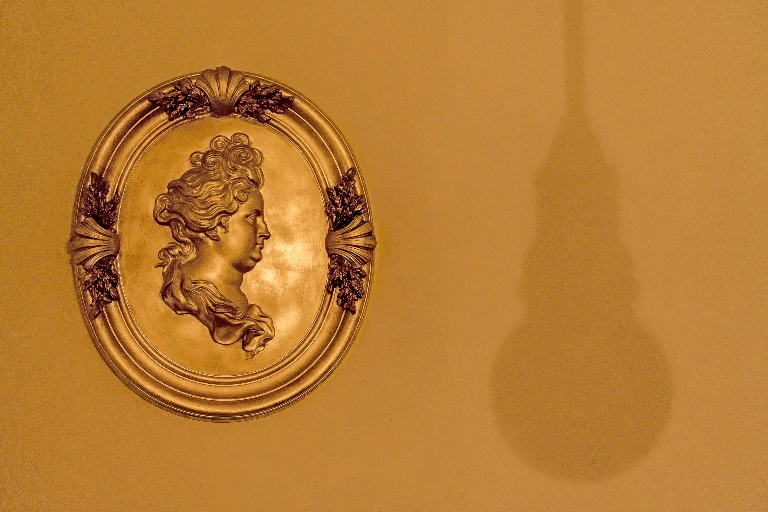 An artifact and the shadow of the light source illuminating it at Berliner Dom in Berlin, Germany .