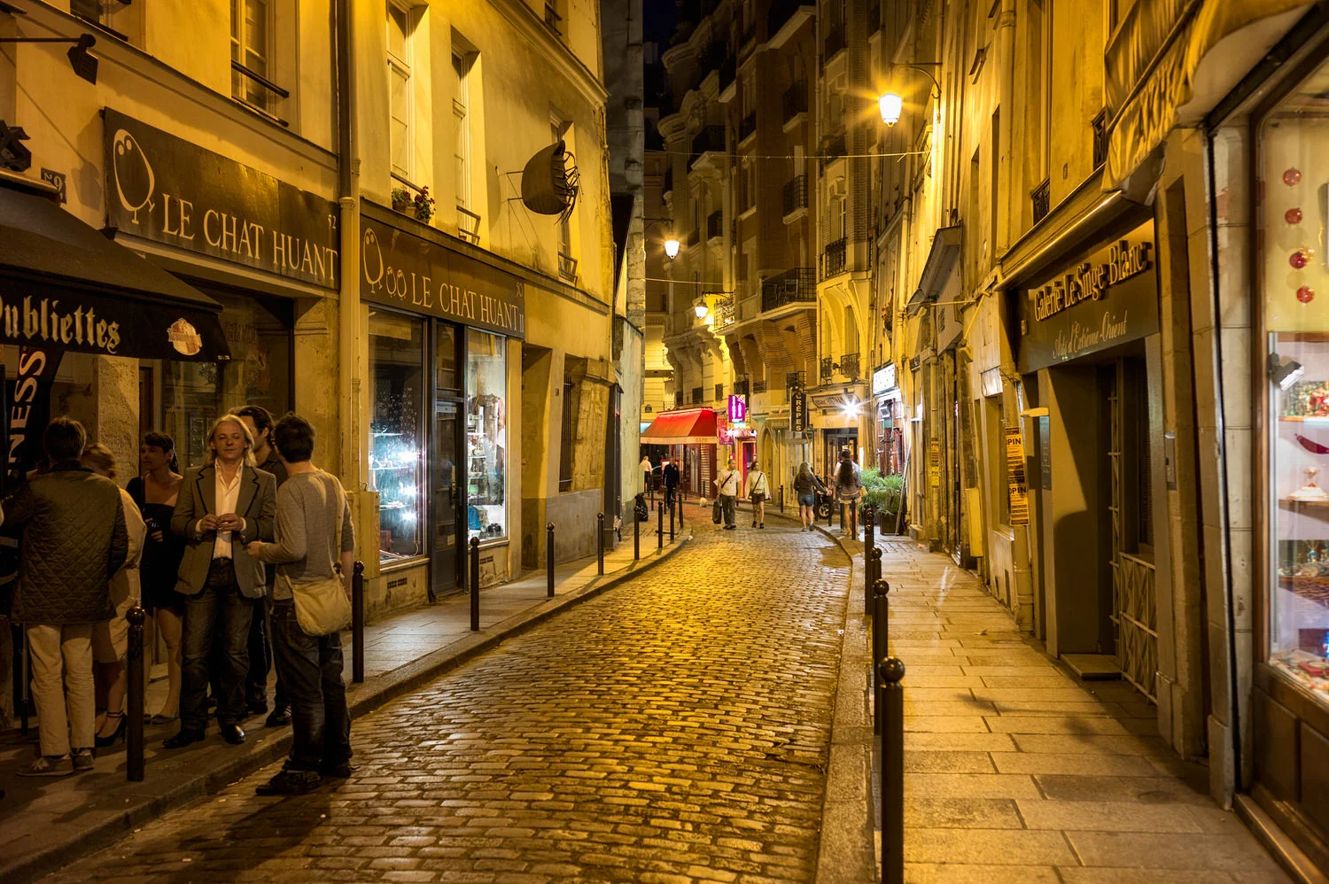 Local parisians enjoying a chat outside a cafe in the Latin Quarter of Paris .