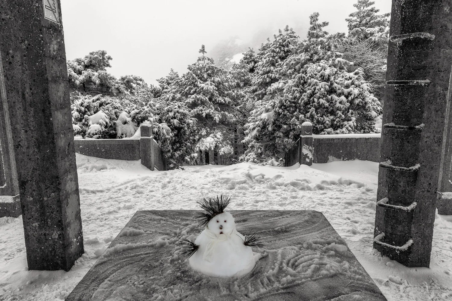 A tiny snowman under a shelter on Huangshan (i.e., Yellow Mountain), China .