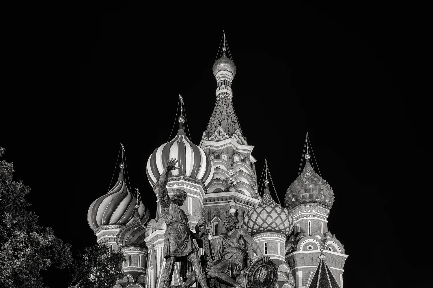 Statue of two heroes, Minin and Prince Pozharsky , in front of St. Basil's Cathedral at night in Moscow, Russia.