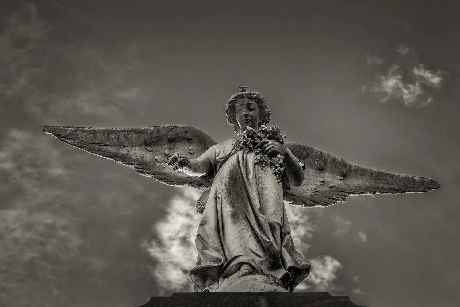 Light in photography evident in this angel statue, La Recoleta Cemetery, Argentina.