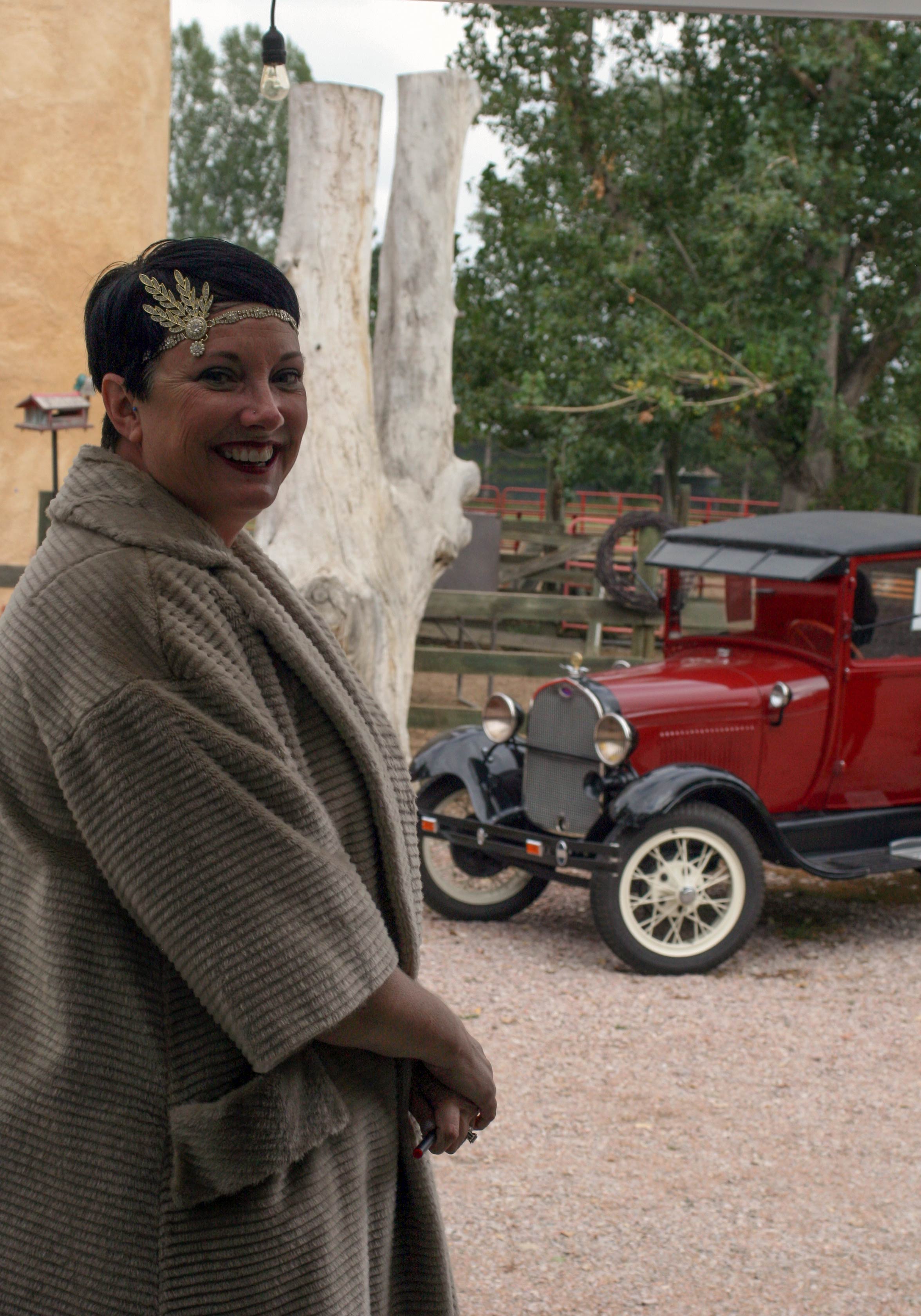 A volunteer docent stands outside the featured farm property at 218 S. Overland Trail