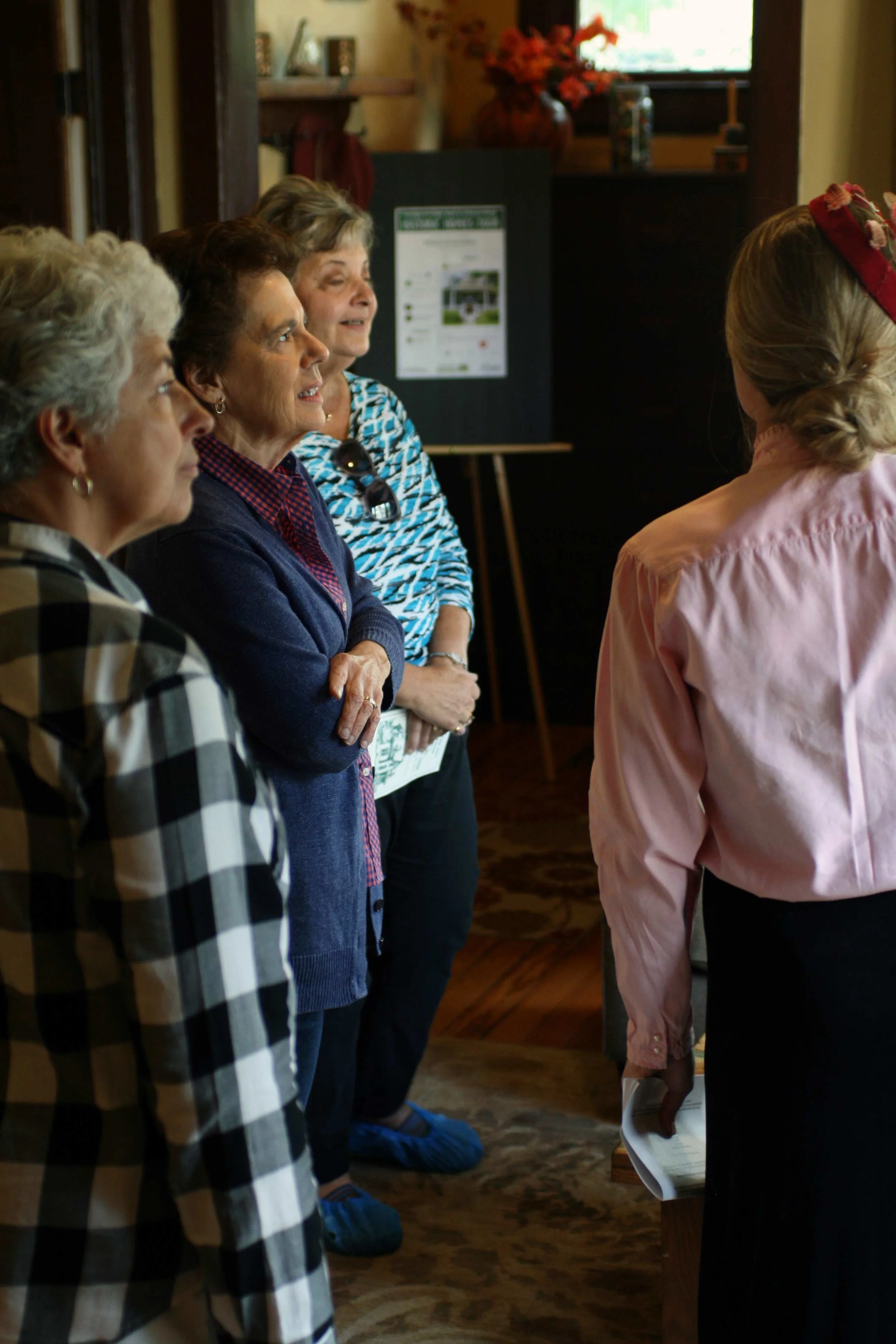 A volunteer docent informs attendees about the antique furniture in a historic home on Smith Street in Fort Collins