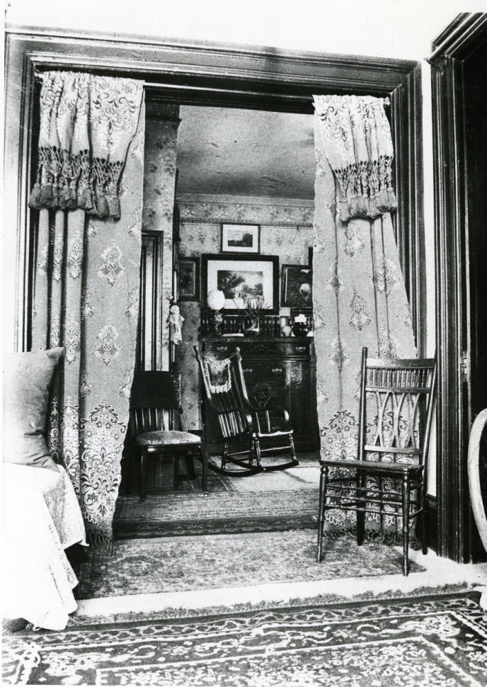  Circa 1900 - Black and white photograph of the interior of the Avery House located at 328 West Mountain Avenue; Fort Collins, Colorado. This is photo is taken from the Parlor looking into the sitting room. 