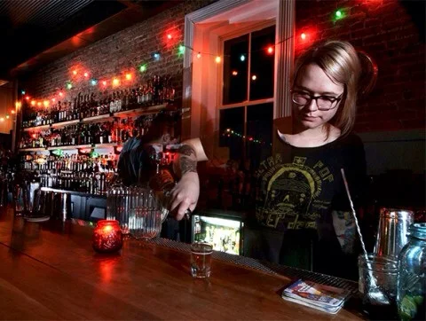  Bartender Amber Yates pours a glass of whiskey at the Silver Dollar Photo by: Thomas Wavid Johns
