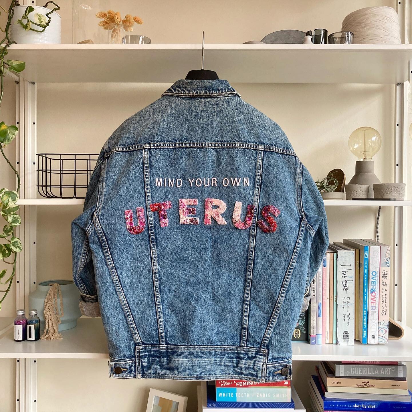 Started this two years ago and finally put it all together&mdash;hand embroidered bead lettering attached to a thrifted oversized denim jacket. #mindyourownuterus  #mybodymychoice