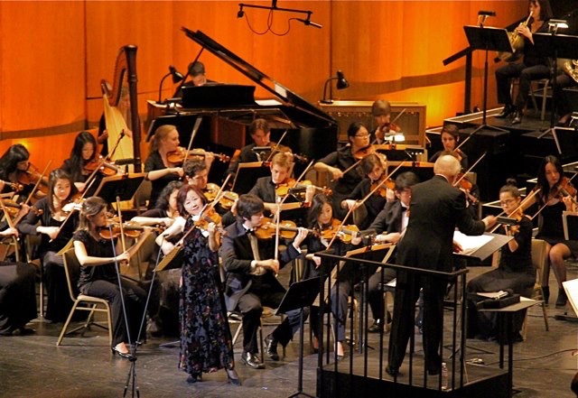 Performing in YMF Debut's Orchestra's 2012 Gala concert under the direction of maestro / composer John Williams, accompanying violinist Bing Wang