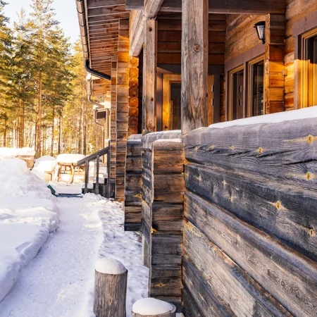 Finnish wooden log house winter time, Råmossa Lodge