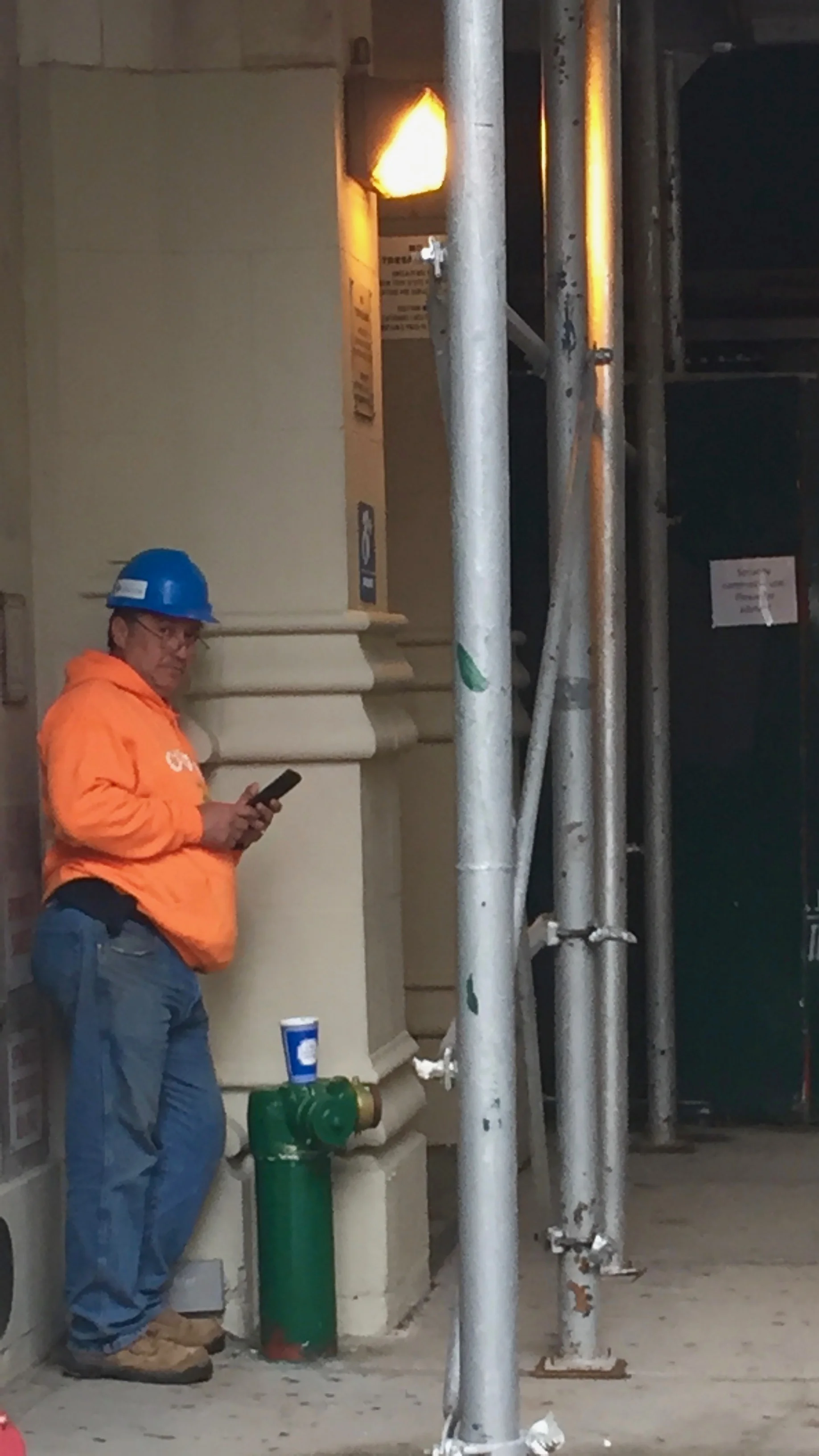 A Construction Foreman in the West Village checks on suppliers