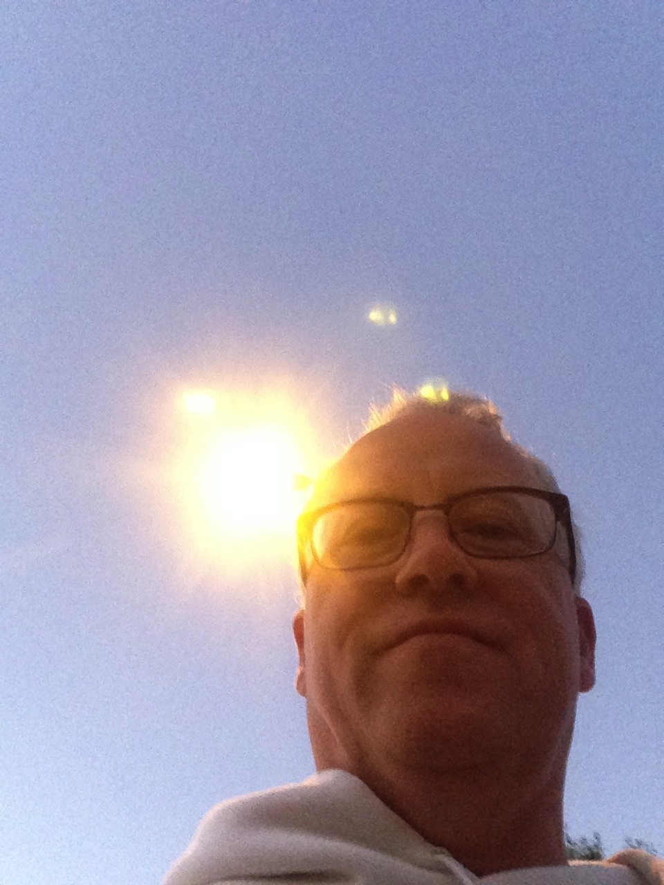 The the tapered, white cement lamp post is behind my head.