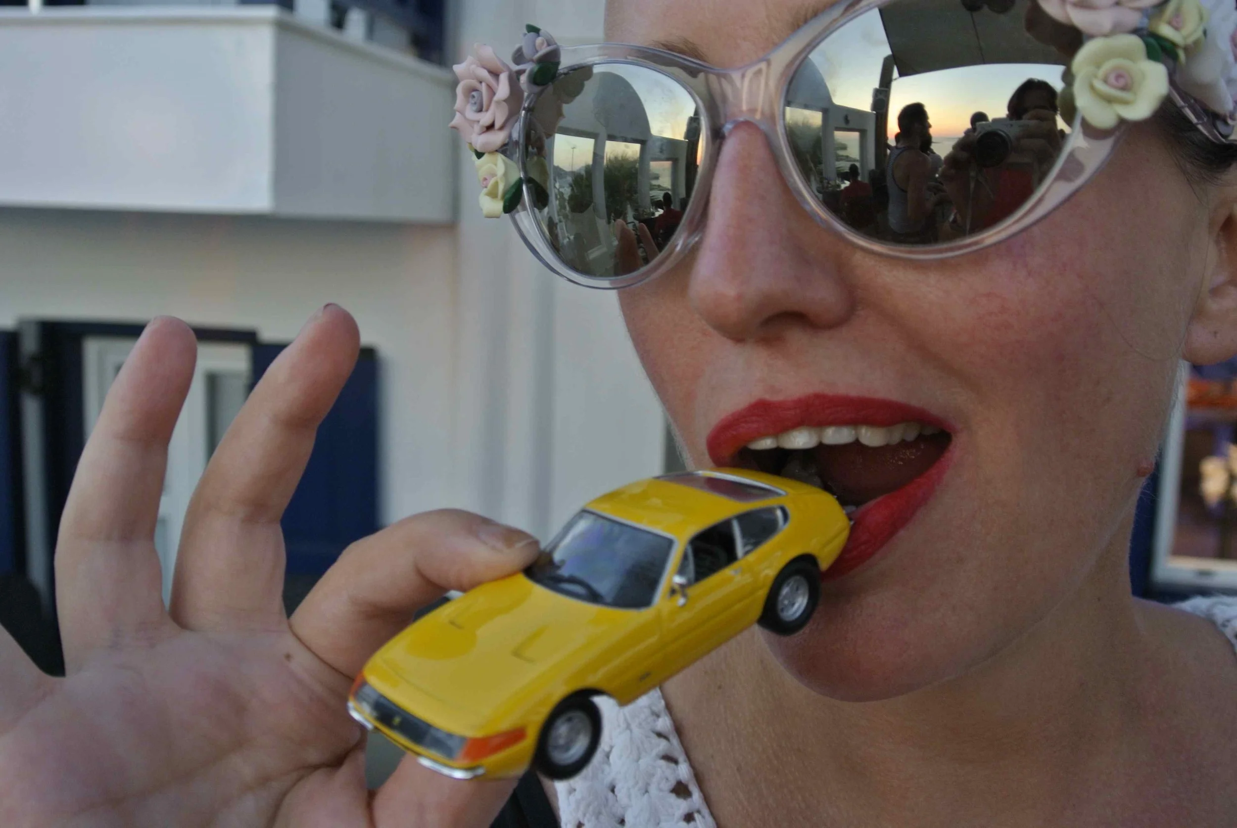 Comedienne Caroline Reid (aka "Pam Ann") auto-fellates the Ferrari 365 GTB "Daytona" in Mykonos, Greece