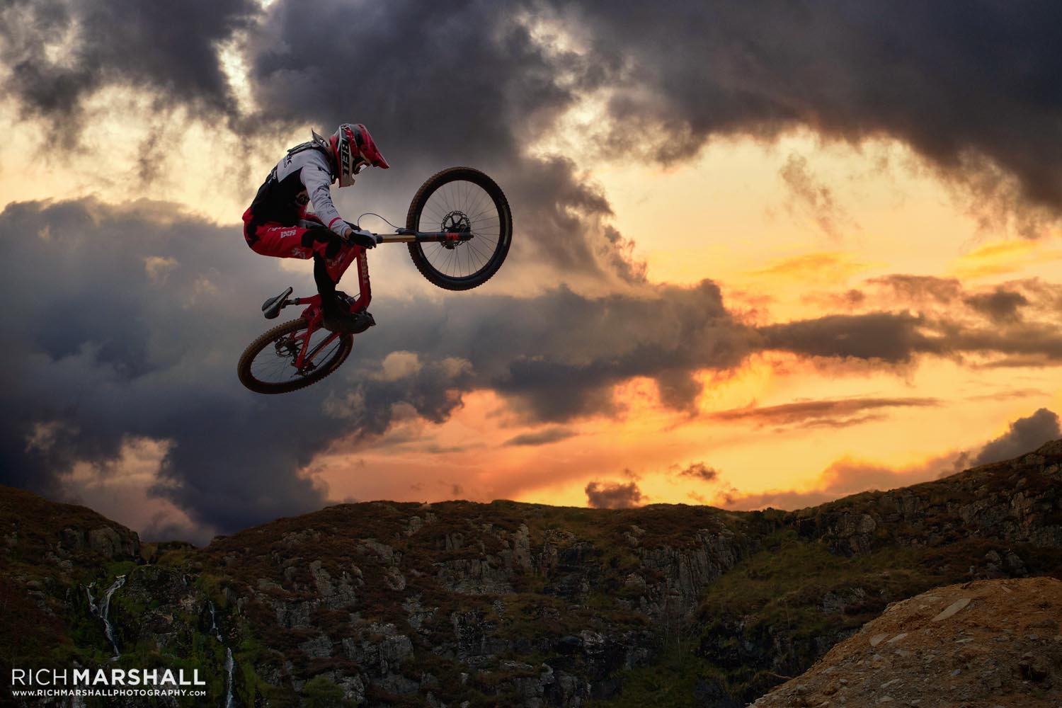 A different more dramatic sky with ground and mountain biker further darkened to add realism.
