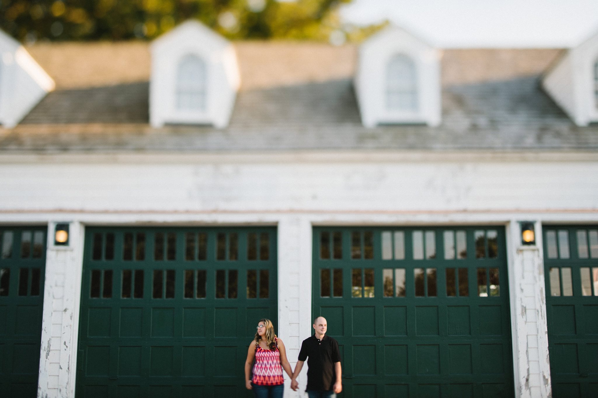 This couple wanted to take pictures near a lighthouse. We pulled into a parking lot and I told them to come stand in front of this garage. The maintenance garage for the park, full of tractors and tools. There are two volunteers near us working on the landscaping. We still took pictures by the lighthouse, but these were my favorite. 