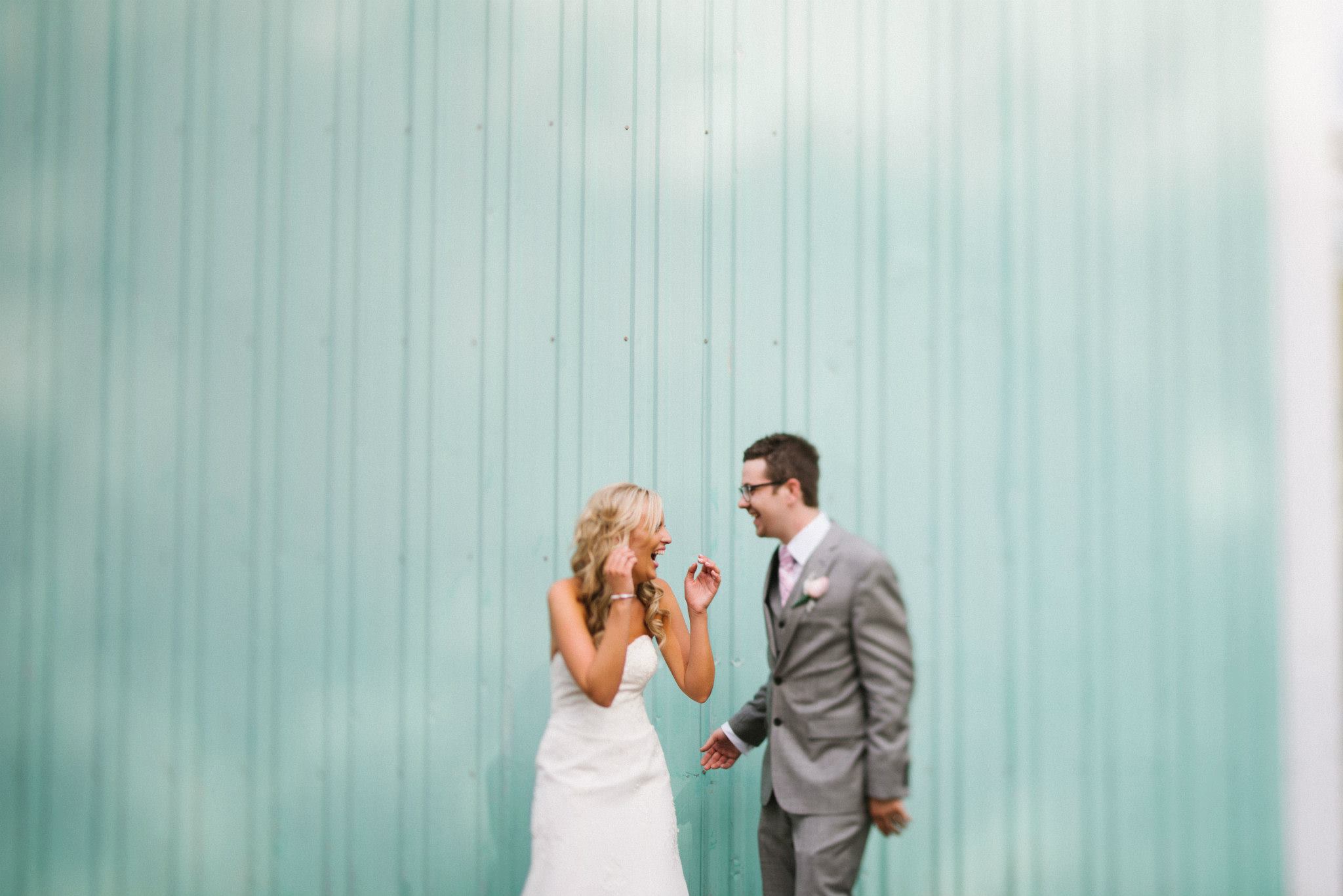 The side of a lawnmower warehouse in Plymouth, MI. We were taking pictures near a fountain when I spotted this bright building a few streets over. The bride and groom were just as pumped as I was and the guys in the warehouse were a lot confused. One even rode over on a commercial size lawnmower and asked if we wanted to use it in the shot. 