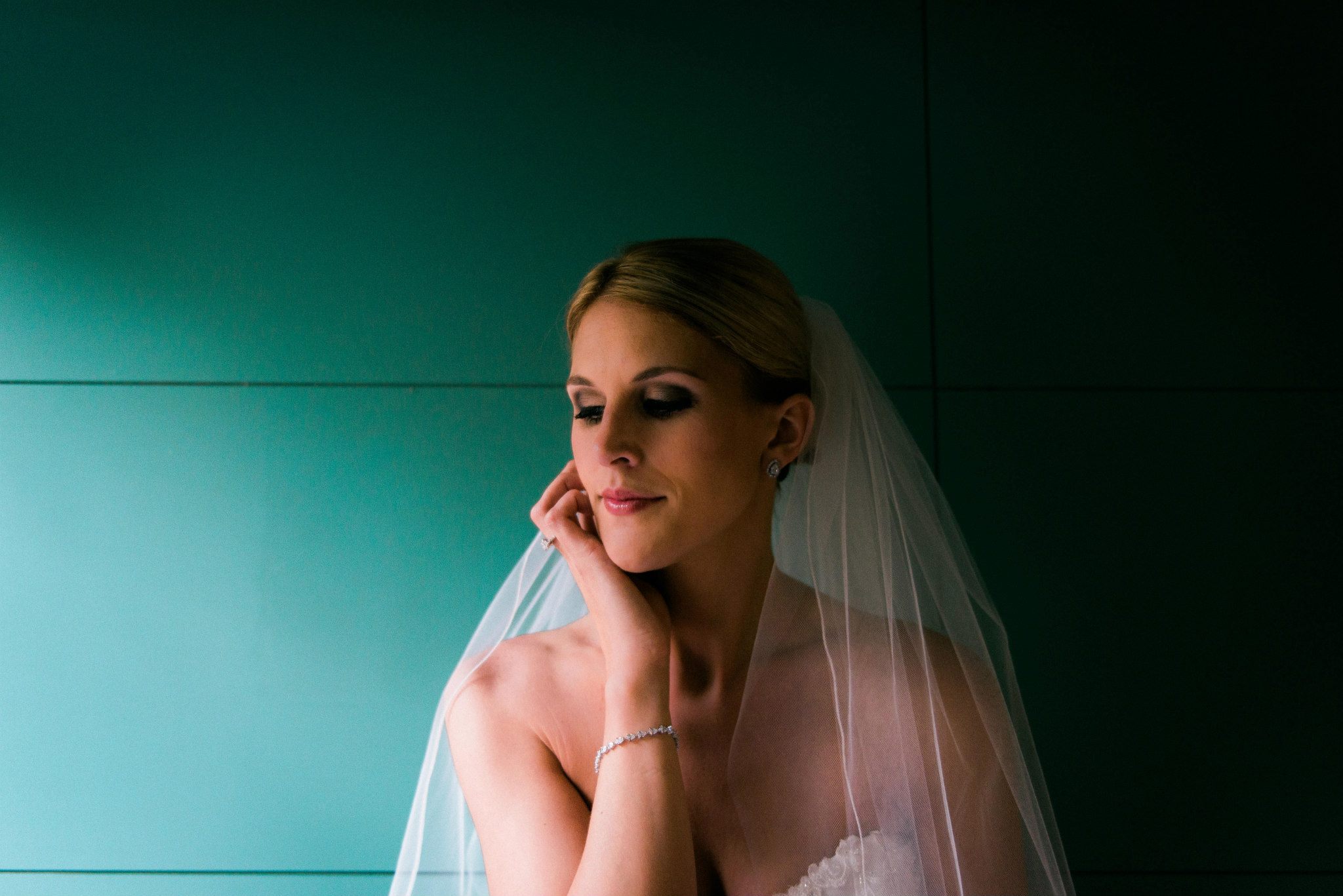 A vestibule of a hotel venue. We were walking inside from taking formals on the beautiful grounds and I stopped the bride for a few portraits. The opening of the doors was creating huge gusts of wind. I have a whole series of the veil blowing, one of the bridesmaids was on wind patrol, opening and closing the door for us. 
