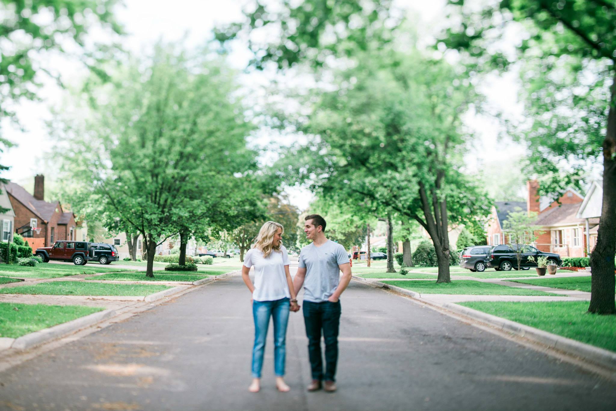 This couple is standing in the middle of the street in front of their first home together. She asked if she needed to put her shoes on. I said, "Do you normally wear shoes?" To which she replied "Nope." Then absolutely you do not have to put your shoes on. I had suggested doing the session at home, and was excited that they were for it. We had zero outfit changes and shot here, in the back yard and inside of the house. Still one of my favorite e-sessions to date. 