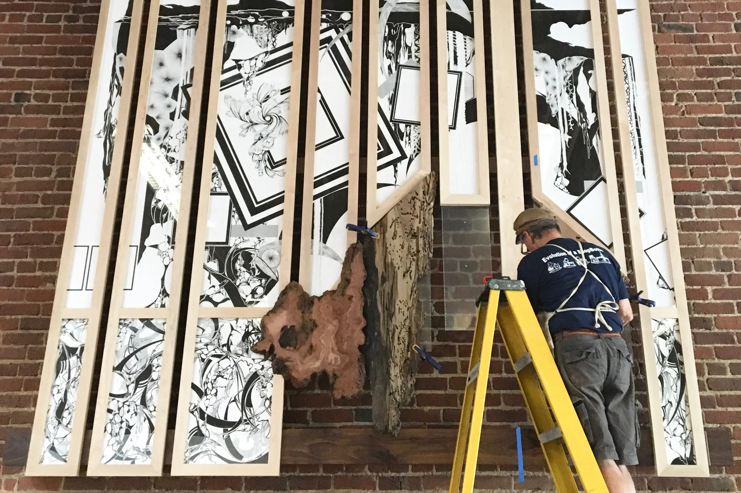 James fitting the frames with a plexiglass backing to attach the redwood pieces.