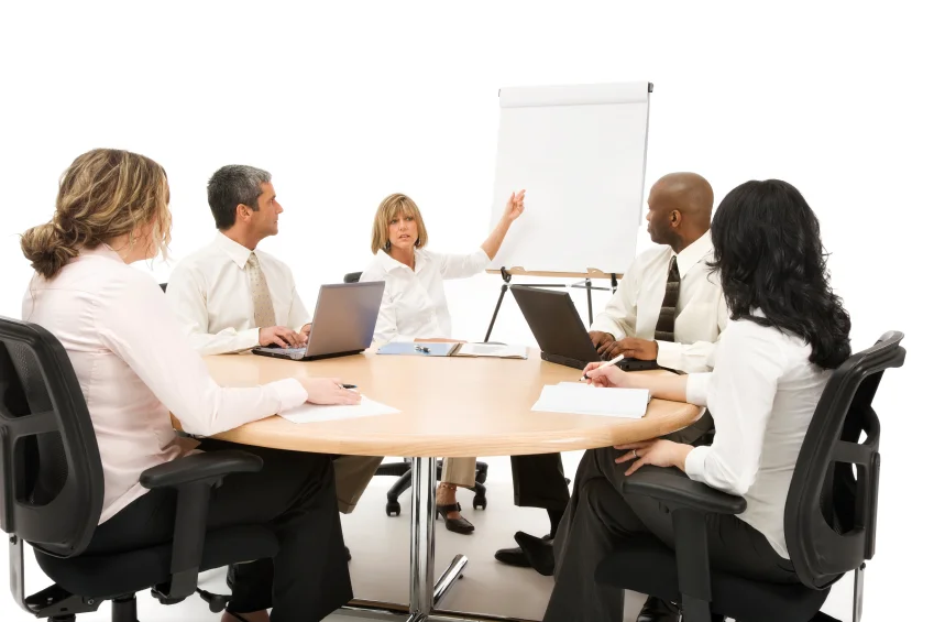 A group of business colleagues sitting around a conference table.
