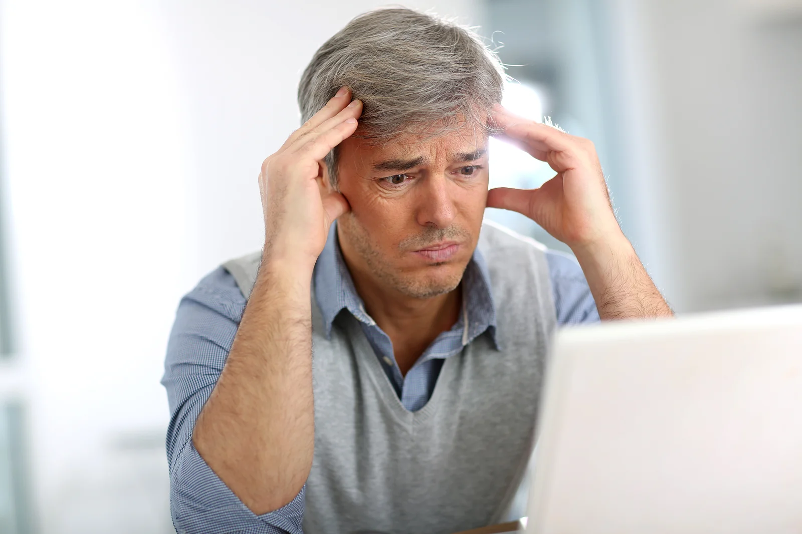 Customer rubbing his temples due to a customer service headache