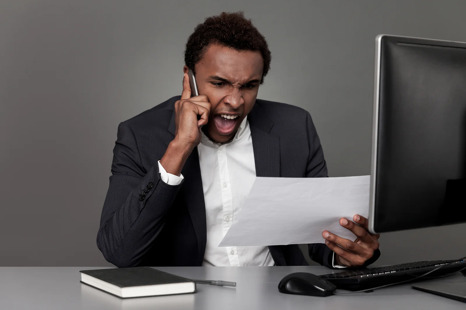 An angry customer yells into the phone.