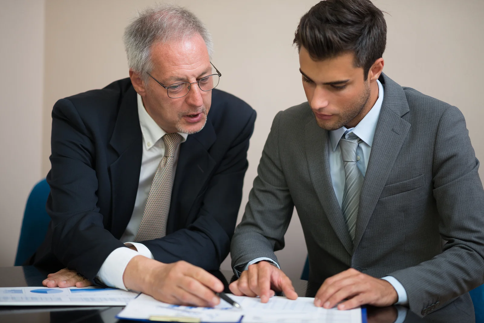 Two professionals analyzing the results of a training evaluation report.