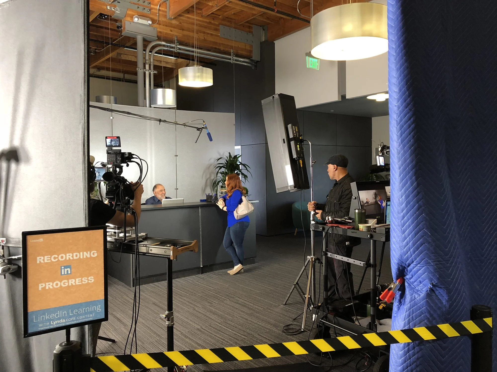 Filming a customer service training video on a reception area set.