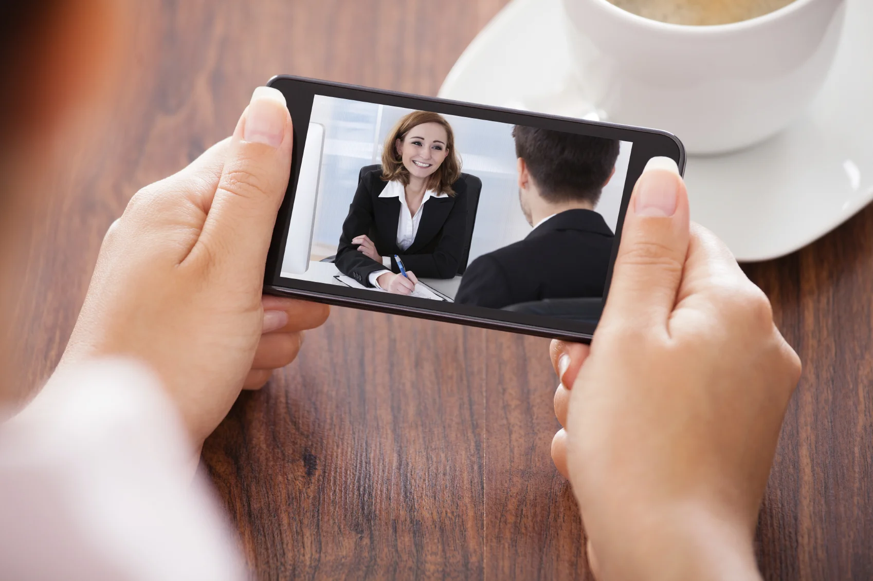 Person watching a training video on a smartphone.