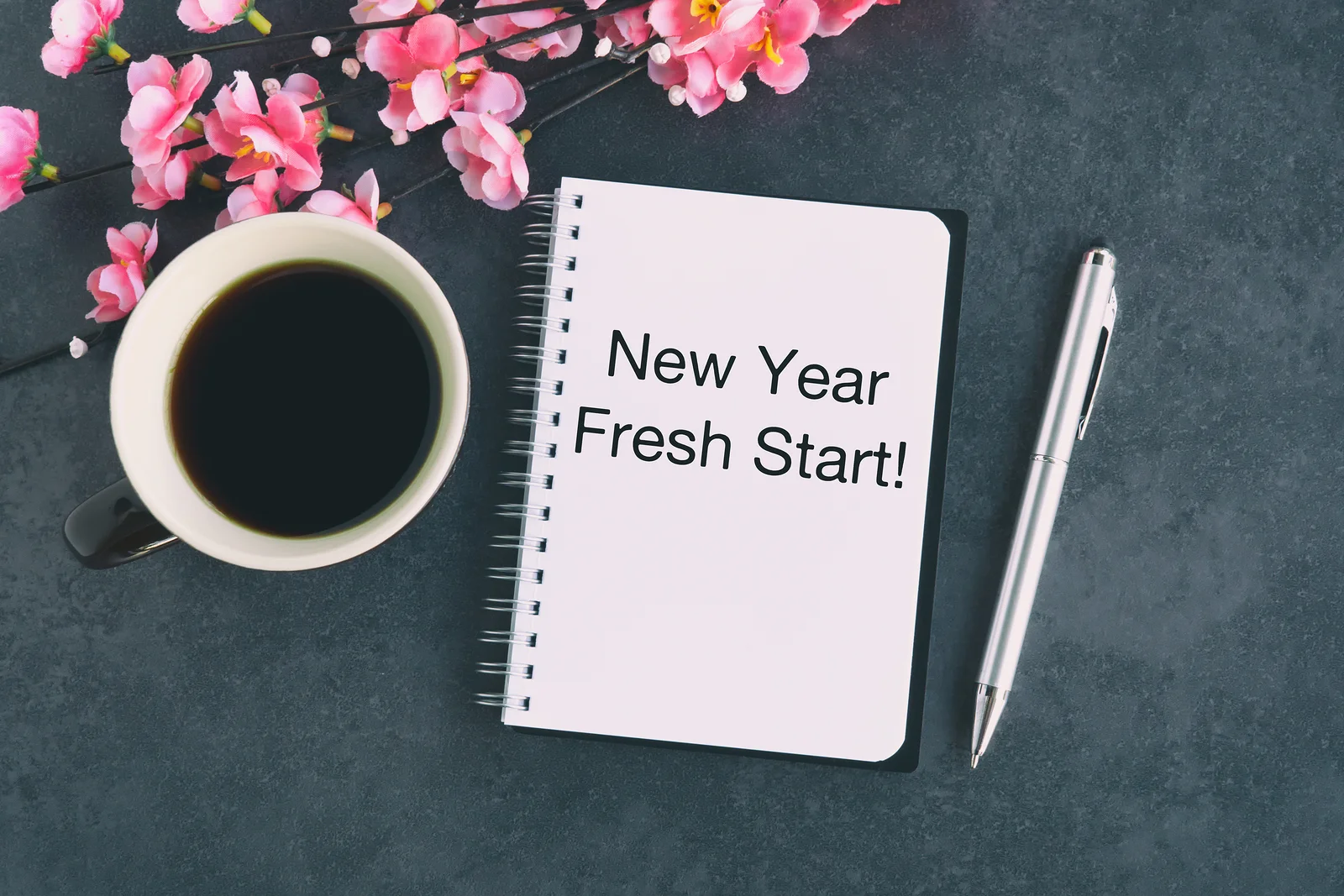 Notepad with “New Year, fresh start!” written on it.