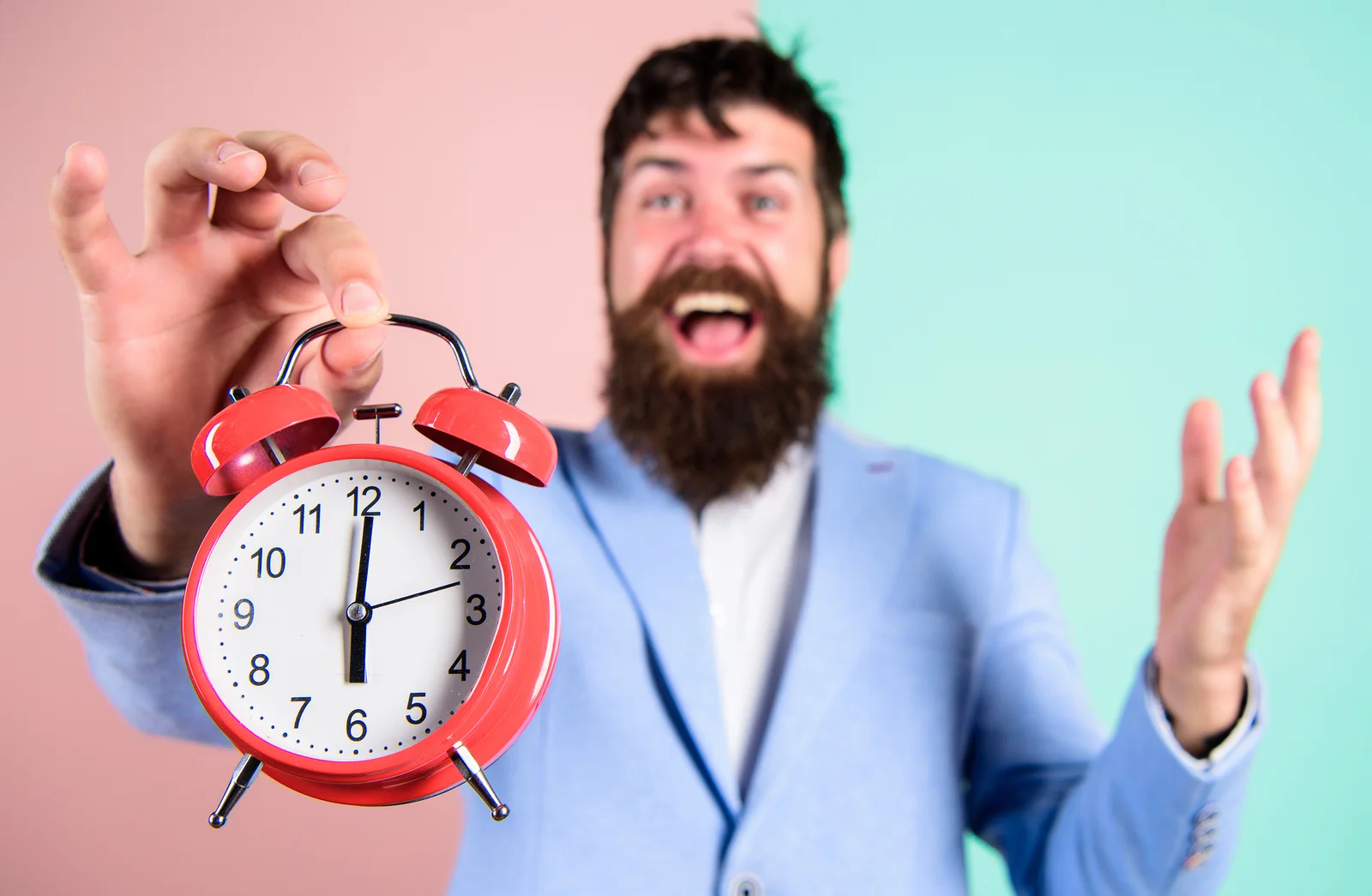 Happy man holding a clock.