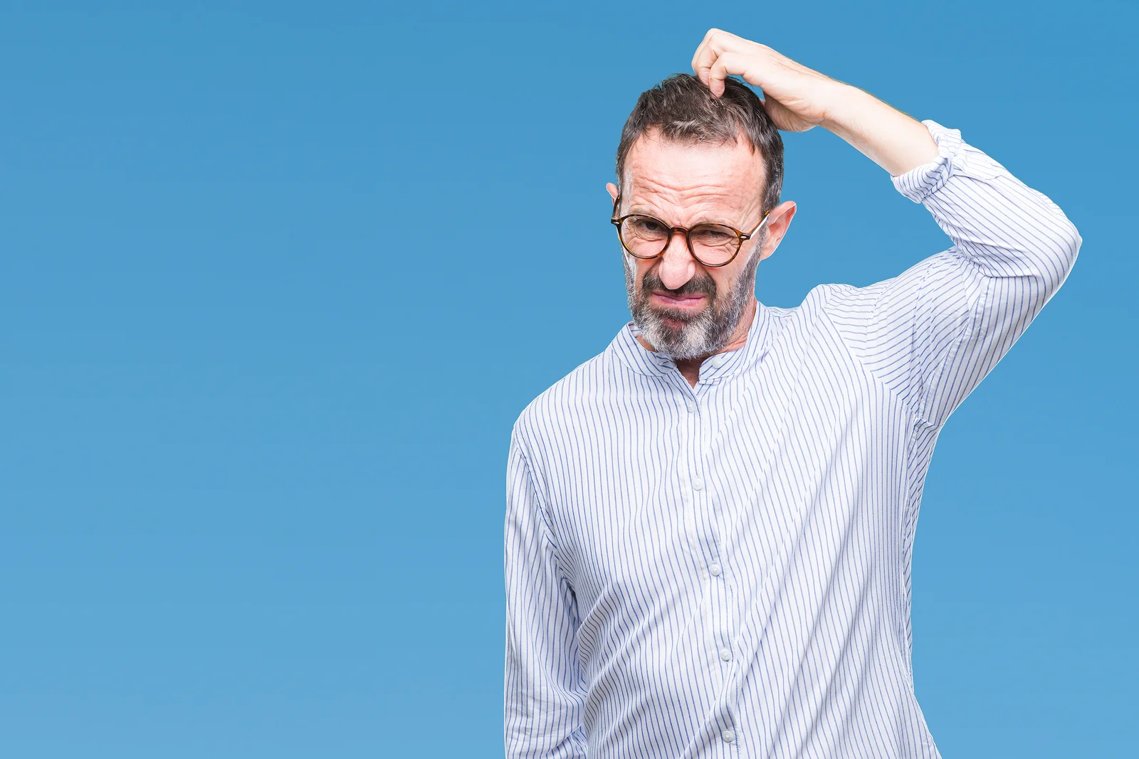 Man scratching his head in confusion.