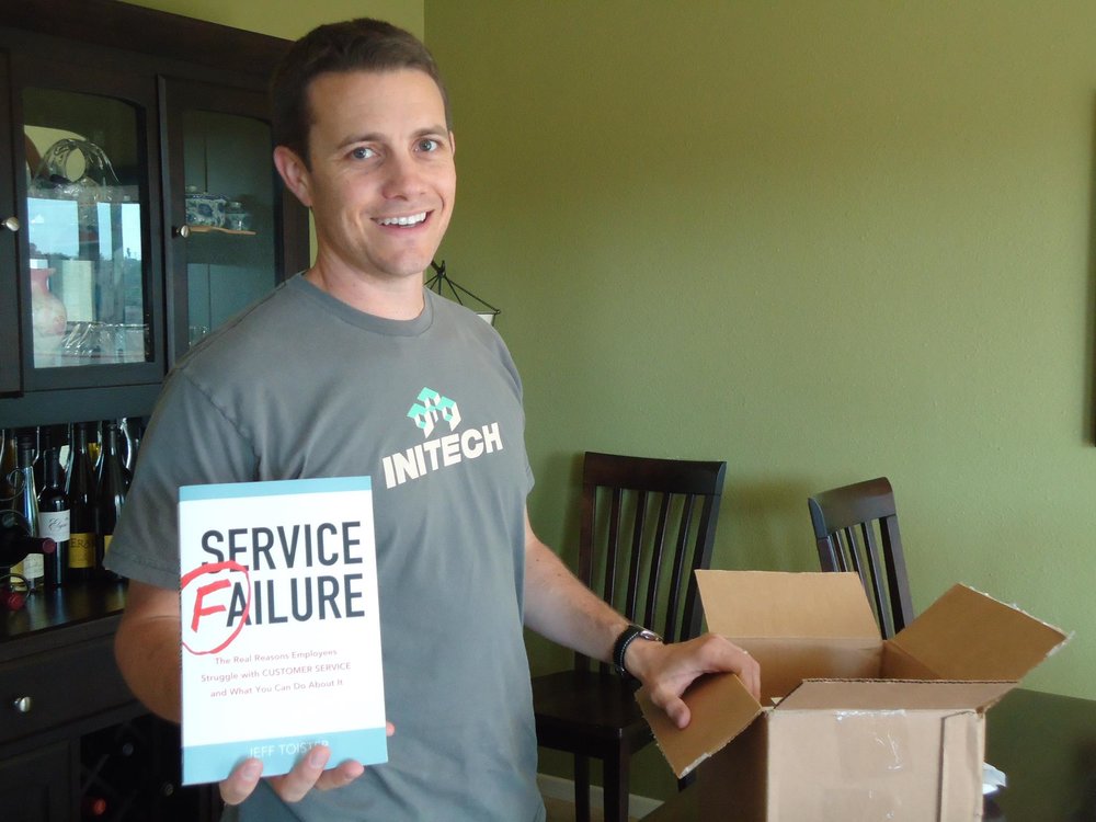 The author holding up a defective copy of his book, Service Failure.