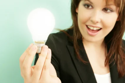A woman holding a lightbulb signifying a bright idea.