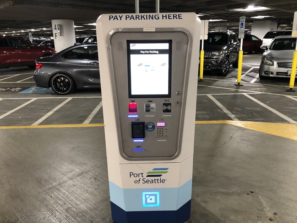 A self-service kiosk in a parking garage.