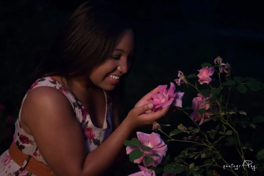 Stunning lady and beautiful flowers.