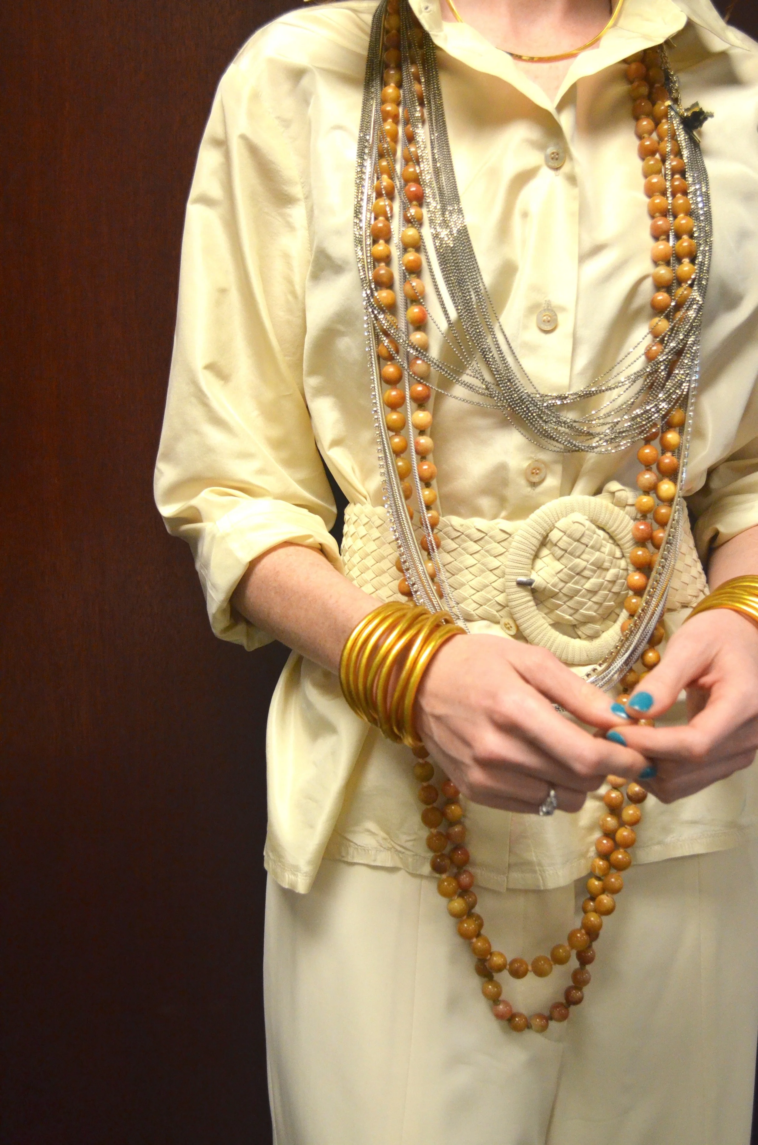 A gold torque , strand necklaces and budhabeads coexist. 
